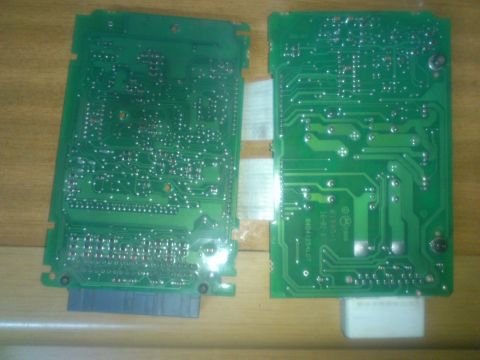 1998 Ford Crown Victoria - Two electronic circuit boards are shown, likely automotive components, with visible text on one.