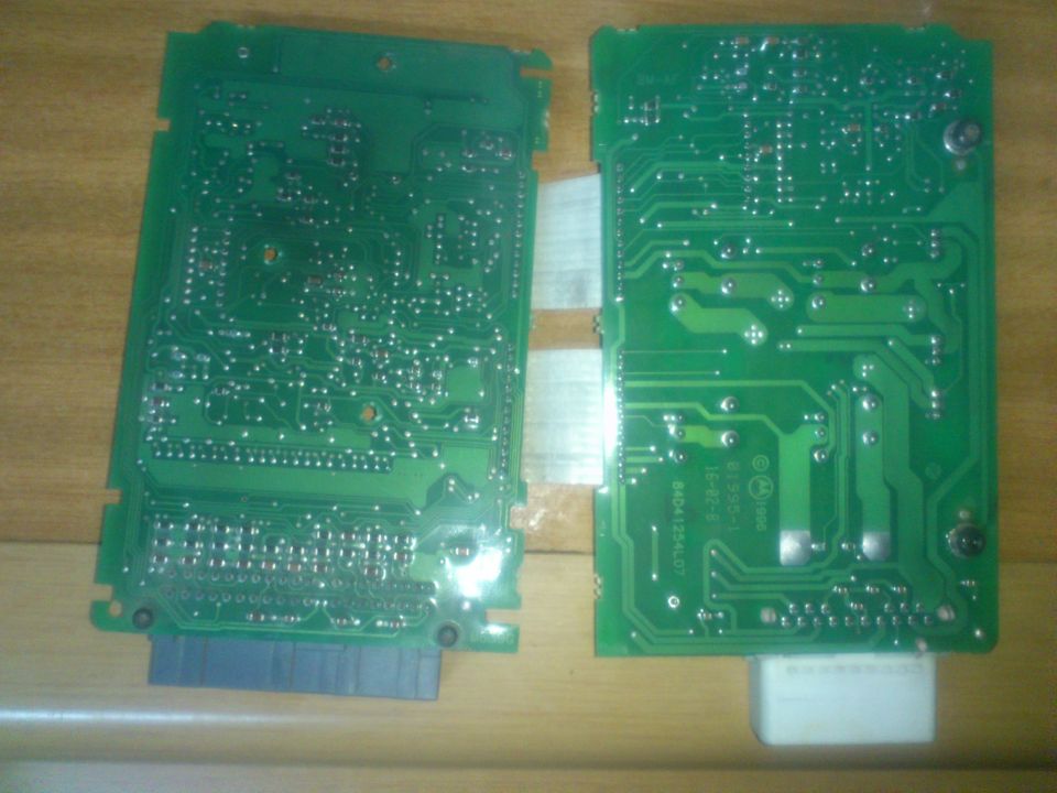 Two green circuit boards with visible components and connectors