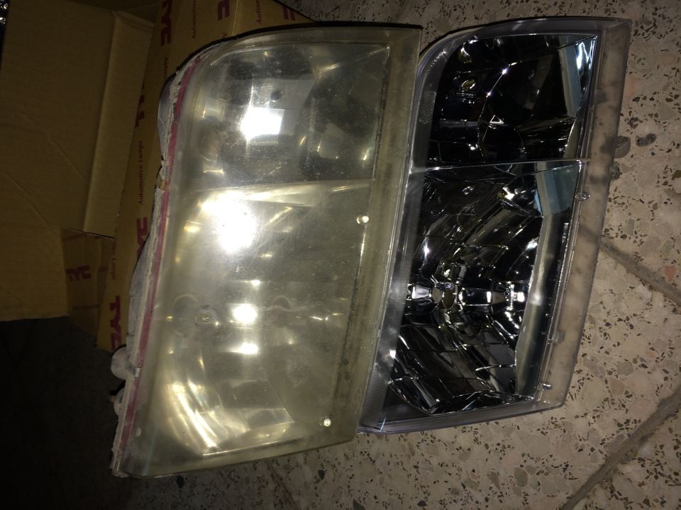 Comparison of a yellowed headlight assembly next to a clear replacement headlight assembly