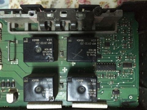 1998 Ford Crown Victoria - A close-up view of a circuit board containing multiple relays and electronic components.