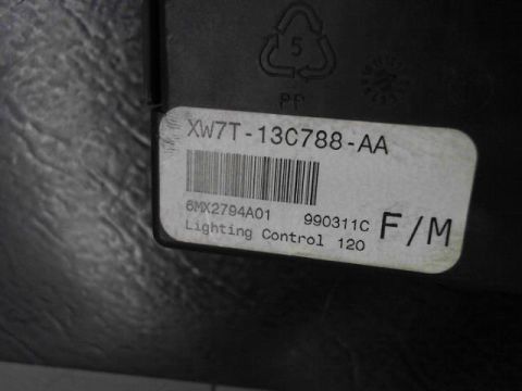 1998 Ford Crown Victoria - A close-up of a lighting control module part, identified by the label XW7T-13C788-AA and part number 6MX2794A01.