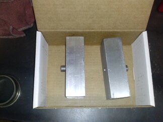 1995 Ford Bronco - Two metal blocks are shown inside a cardboard box. The SuperMotors logo is visible at the bottom of the image.