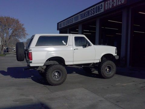 1995 Ford Bronco - This lifted 1995 Ford Bronco features a rear-mounted spare tire and aggressive off-road tires.