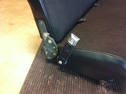 1982 Ford Bronco - Seatbelt buckle and mounting bracket detail on a car seat.
