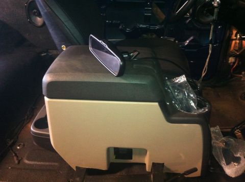 1982 Ford Bronco - Interior view of a vehicle's center console area with various parts and a rearview mirror.