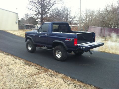 1982 Ford Bronco - This 1982 Ford Bronco 4x4 is shown from the rear with its tailgate open, revealing the cargo bed.