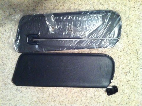 1982 Ford Bronco - Two black sun visors are shown, one still in its original plastic packaging.