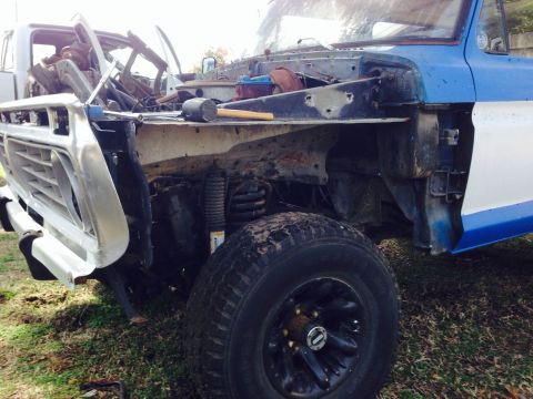 1979 Ford Bronco - This truck is missing its hood and fenders, revealing the engine compartment and suspension components.