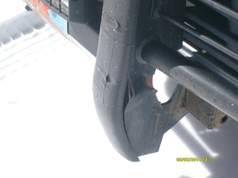 1991 Land Rover Range Rover - Close-up of a damaged front bumper corner on a 1991 Land Rover Range Rover.