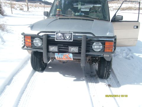 1991 Land Rover Range Rover - This 1991 Land Rover Range Rover is parked in the snow with its driver's side door open.