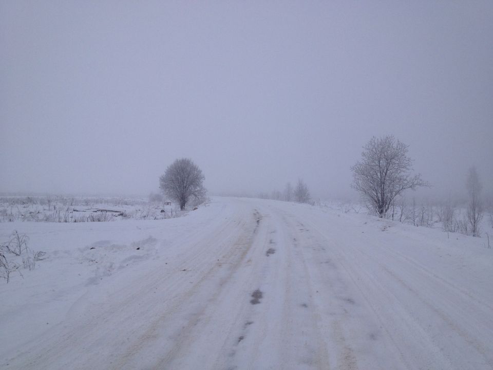 Snowy road with trees and a SUPERMOTORS watermark