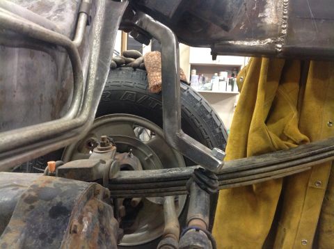 1993 Ford Bronco - Detail shot of a vehicle's rear suspension components, including leaf springs and a tire.