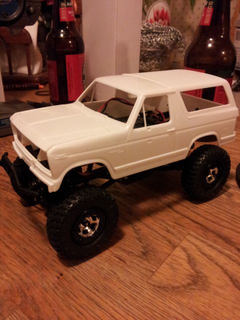 1995 Ford Bronco - A white model SUV sits on a wooden floor, with red wires visible inside.