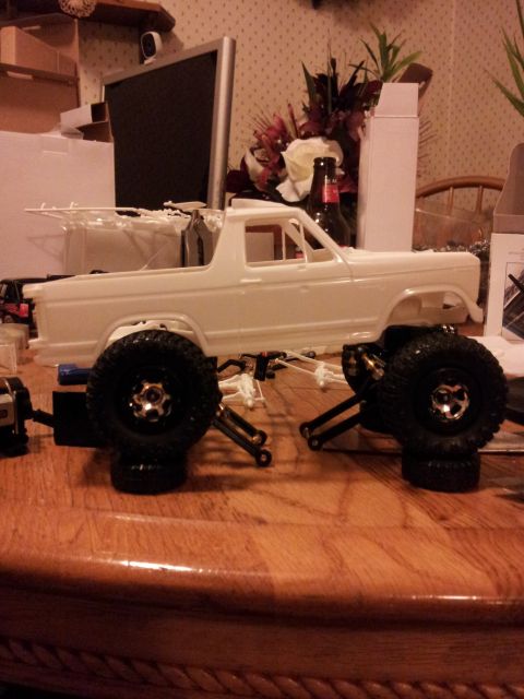 1995 Ford Bronco - A white model truck body is shown assembled with large off-road tires and visible chassis components.