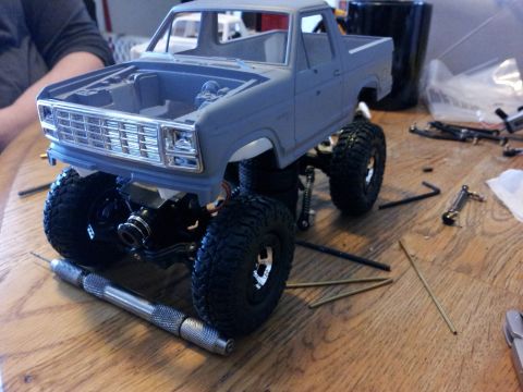 1995 Ford Bronco - Model truck with a grille resembling an early 1980s Ford Bronco sits on a table with various tools.