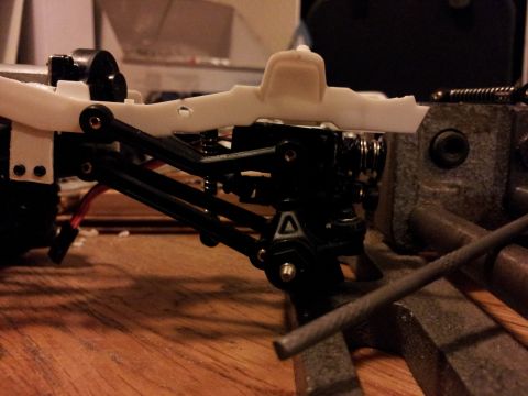 1995 Ford Bronco - Close-up view of a remote-controlled car's chassis being assembled.