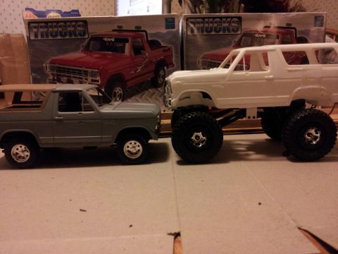 1995 Ford Bronco - Two model trucks are displayed side-by-side, with boxes indicating they are model trucks.