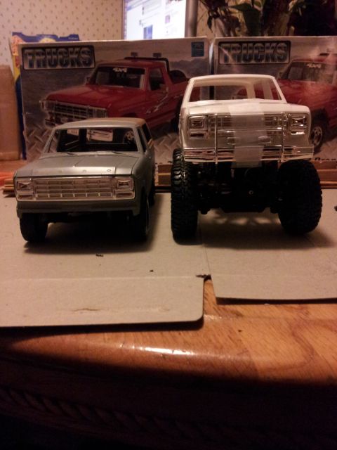 1995 Ford Bronco - Model trucks are displayed on a table with boxes in the background.