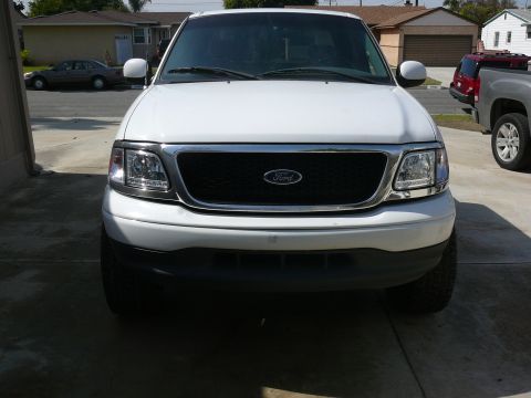 1988 Ford Bronco - This 2001 Ford F-150 is shown from the front, with another vehicle partially visible on the right side.