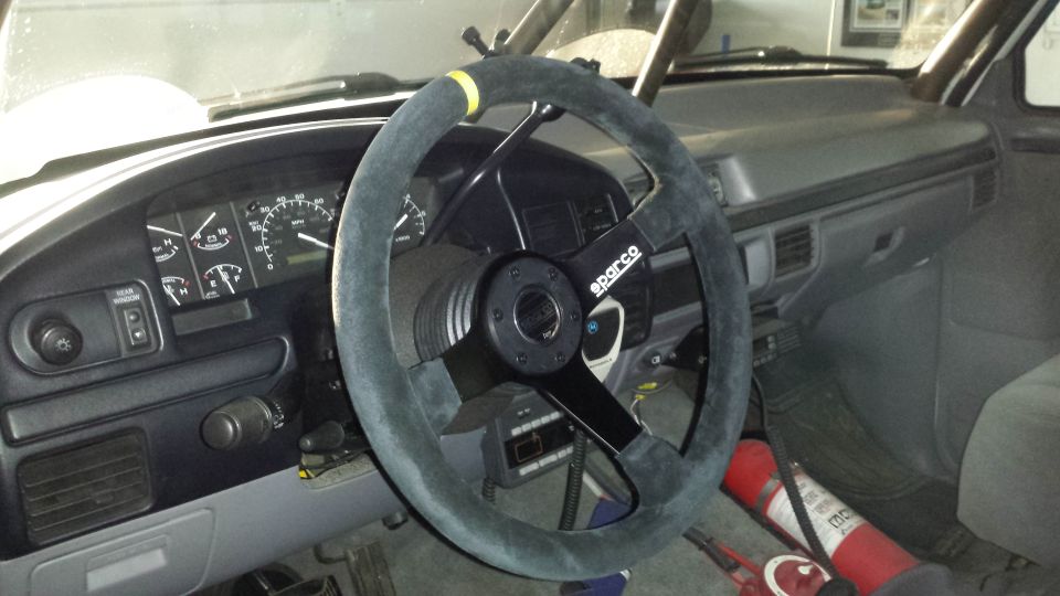 1996 Ford Bronco interior showing Sparco steering wheel and dashboard gauges