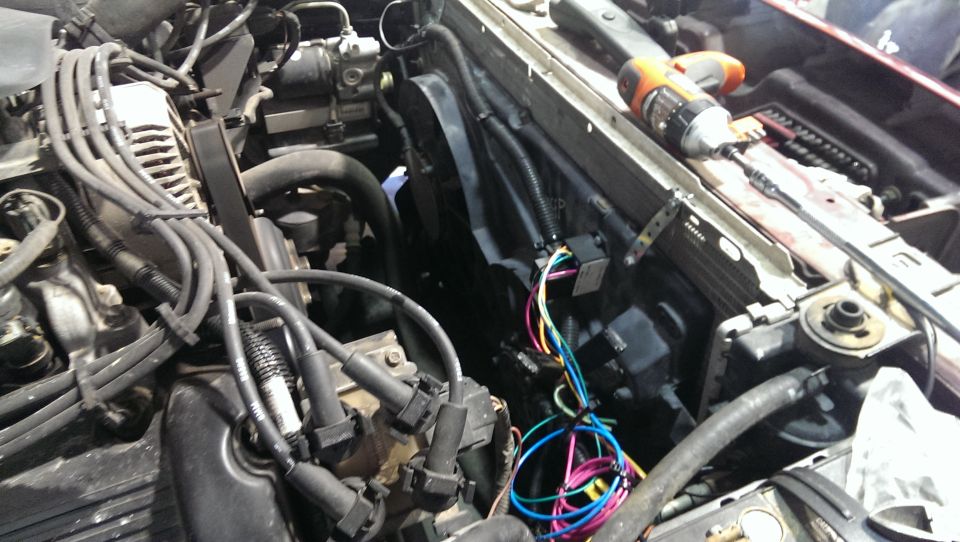 Engine bay wiring and radiator with a drill on top