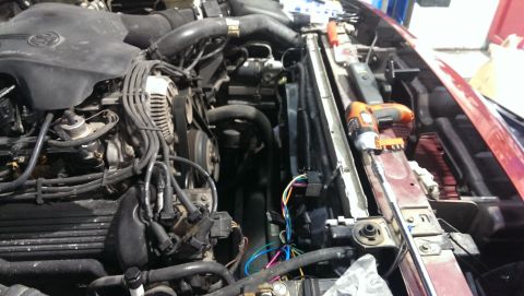 2000 Mercury Grand Marquis - Engine bay components including radiator and alternator, with tools nearby.