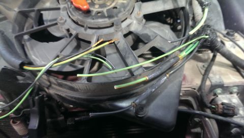 2000 Mercury Grand Marquis - Radiator fan motor with exposed wiring, possibly needing repair or replacement.