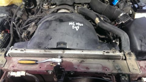 2000 Mercury Grand Marquis - Close-up of a vehicle's engine bay, focusing on the fan shroud and radiator area.