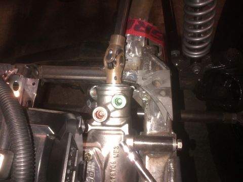 1985 Jeep CJ7 - Close-up of a vehicle's steering system components, including the gearbox and part of the steering column.