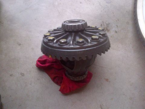 1985 Jeep CJ7 - A differential carrier with bearings is shown resting on a red cloth on a concrete surface.