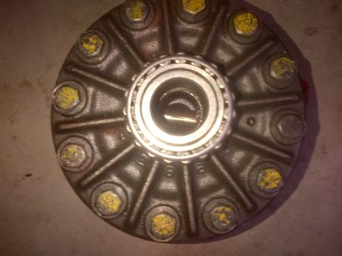 1985 Jeep CJ7 - Close-up of a differential cover with multiple bolts and a central bearing, likely a spare part.