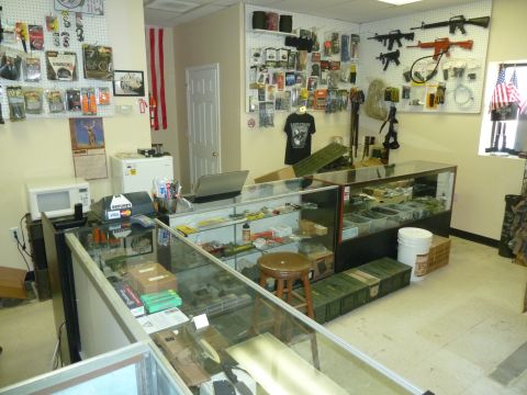 1992 Ford Mustang - This store appears to sell tactical gear, firearms, and related accessories, with display cases and wall-mounted items.