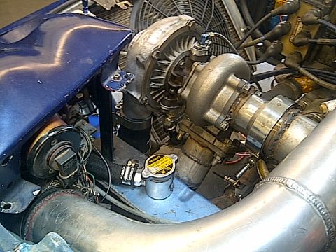 1995 Ford Probe - This image shows a close-up view of engine components, including a turbocharger and associated plumbing.