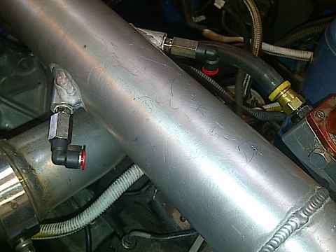 1995 Ford Probe - Close-up view of engine components, including aluminum piping and various hoses.
