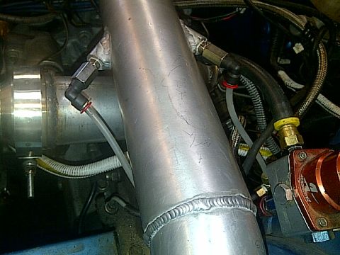 1995 Ford Probe - Close-up view of engine components including a large aluminum pipe, various hoses, and a red part. Text from a watermark is visible.