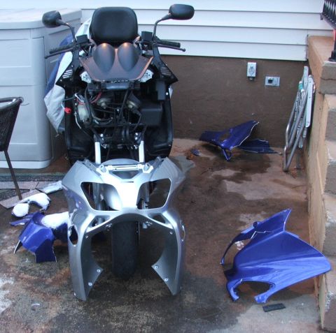 2006 Honda Reflex - The front fairing of a scooter has been removed, revealing its internal components.