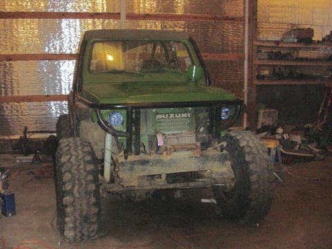 1992 Ford Bronco - This modified green Suzuki features a front winch and oversized tires, suggesting off-road capabilities.