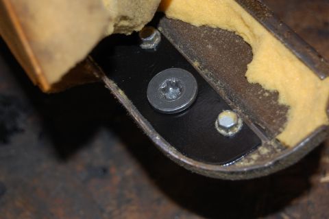 1994 Ford Bronco - Seat bracket repair detail showing mounting hardware and foam padding.
