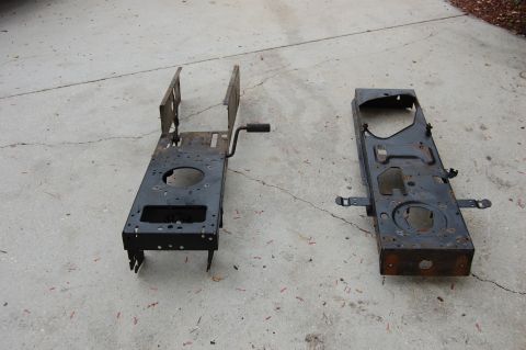 2006 Honda RANCHER - Two frames for a lawn mower sit on a concrete surface, likely for repair or replacement.