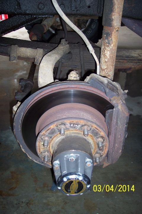 1973 Ford F-250 - Close-up of a vehicle's front wheel hub and brake system, a locking hub.