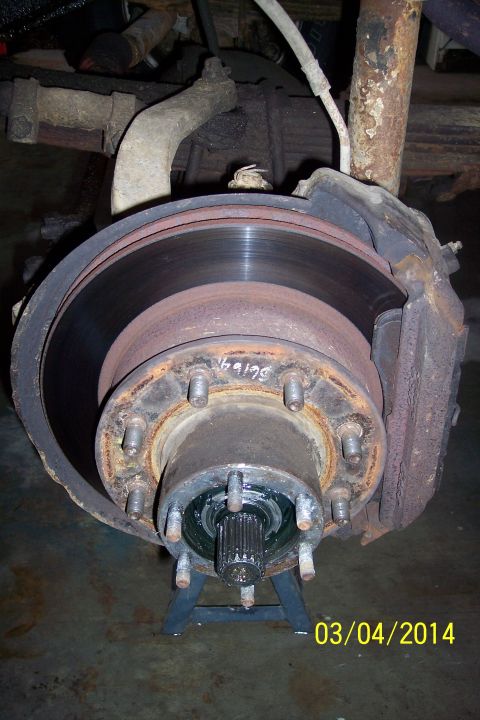 1973 Ford F-250 - Close-up of a vehicle's front wheel hub and brake assembly, showing rust and wear.