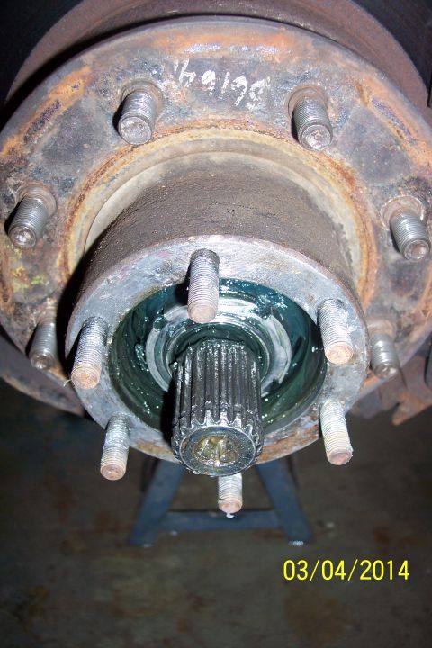 1973 Ford F-250 - Close-up of a greased wheel hub assembly, showing the splined axle shaft and mounting studs.