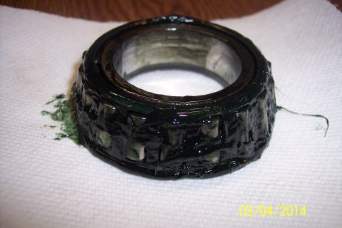 1973 Ford F-250 - A wheel bearing, coated in grease, is placed on a paper towel, with a website URL visible at the bottom right.