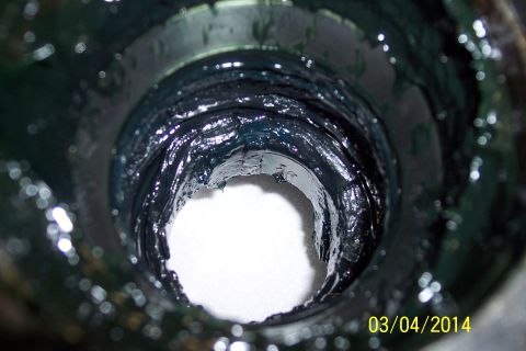 1973 Ford F-250 - Wheel bearing housing filled with grease, showing internal components.