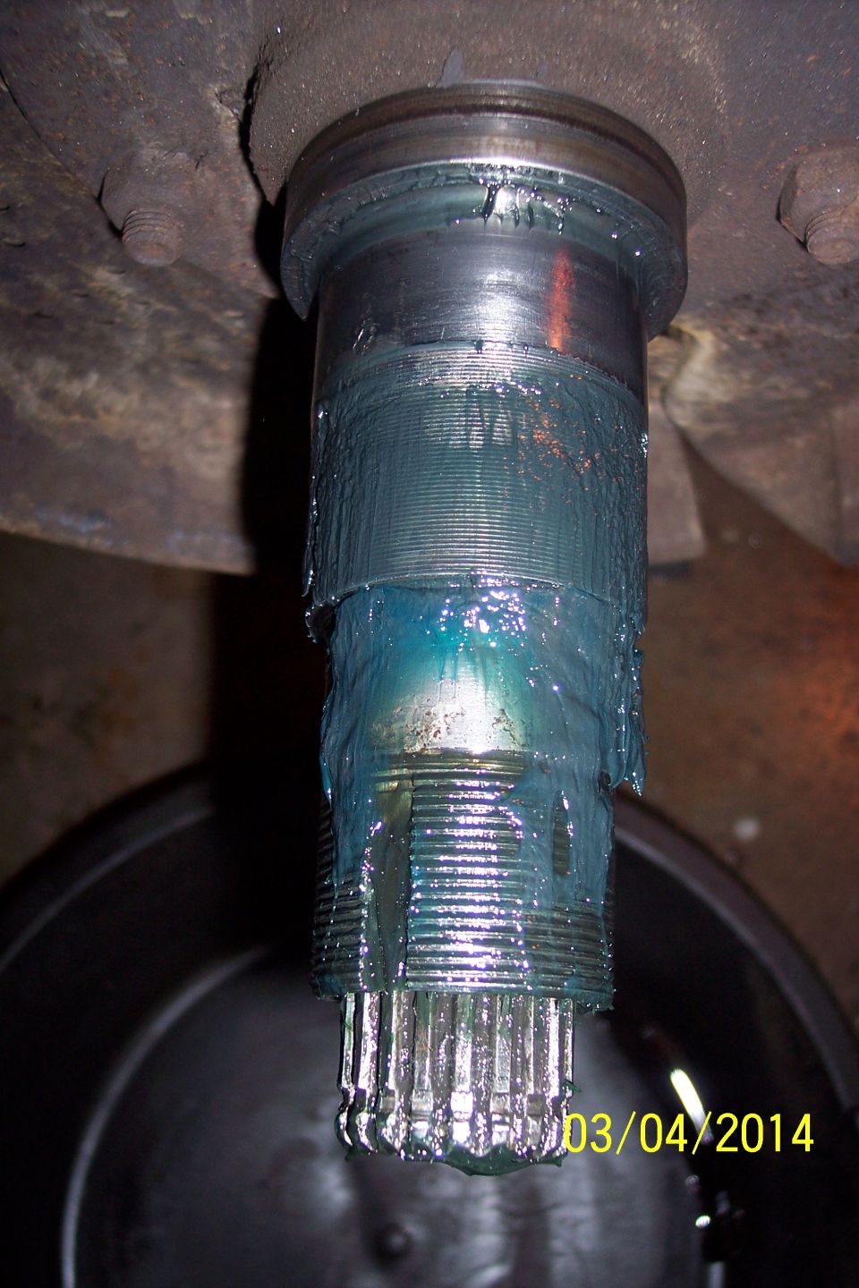 Greased splined shaft with visible teeth, likely a CV joint component