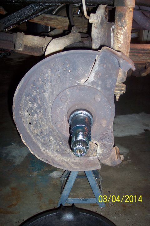 1973 Ford F-250 - Close-up of a vehicle's front knuckle and brake dust shield assembly.
