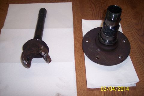 1973 Ford F-250 - Two automotive parts, a knuckle joint and a wheel hub, are laid out on paper towels.