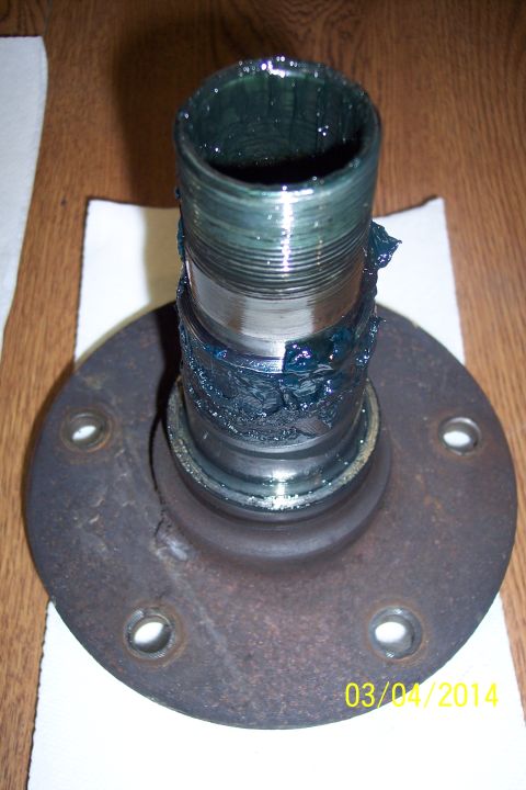1973 Ford F-250 - A close-up view of a greased wheel hub and spindle, likely a component from a vehicle's suspension or drivetrain.
