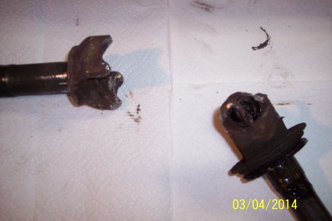 1973 Ford F-250 - Close-up of two worn metal joint components, likely from a vehicle's suspension or steering system.