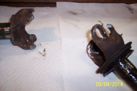1973 Ford F-250 - Close-up of two corroded metal knuckle joint parts laid out on a paper towel.